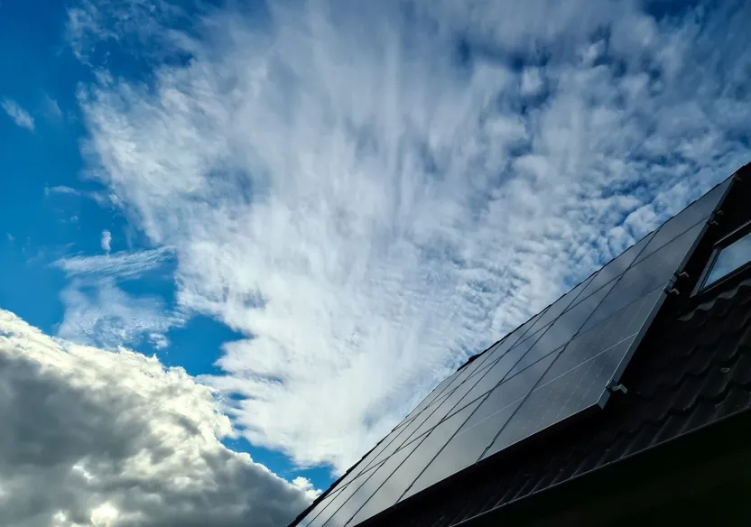 A rooftop solar panel installation working under cloudy conditions